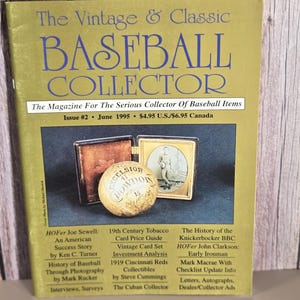 May include: A magazine titled The Vintage & Classic Baseball Collector, Issue #2, June 1995. The cover features a tan baseball with text and a small framed photograph of a baseball player. The background is olive green with black text.