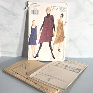 May include: A Vogue Patterns 7114 sewing pattern envelope featuring illustrations of three sleeveless dresses in blue, maroon, and tan. The envelope displays the text 7114, PATTERN/PATRON, 14-16-18, and VOGUE PATTERNS. Included are folded paper pattern sheets.