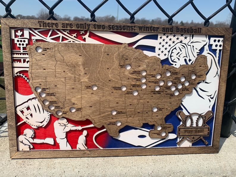 May include: A wooden map of the United States with the location of all Major League Baseball stadiums marked. The map is surrounded by a baseball-themed design, including a baseball glove, a baseball bat, and a baseball player. The text "There are only two seasons: winter and baseball" is written at the top of the map. The text "Play Ball!" is written at the bottom of the map.