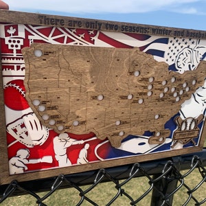 May include: A wooden map of the United States with baseball stadiums marked. The map is surrounded by a red, white, and blue baseball-themed design. The text "There are only two seasons: winter and baseball" is at the top of the map.