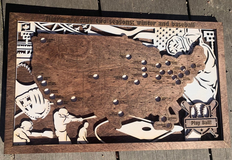 May include: A wooden map of the United States with a baseball theme. The map shows the location of all Major League Baseball stadiums. The text "There are only two seasons: winter and baseball" is at the top of the map. The text "Play Ball!" is at the bottom of the map.