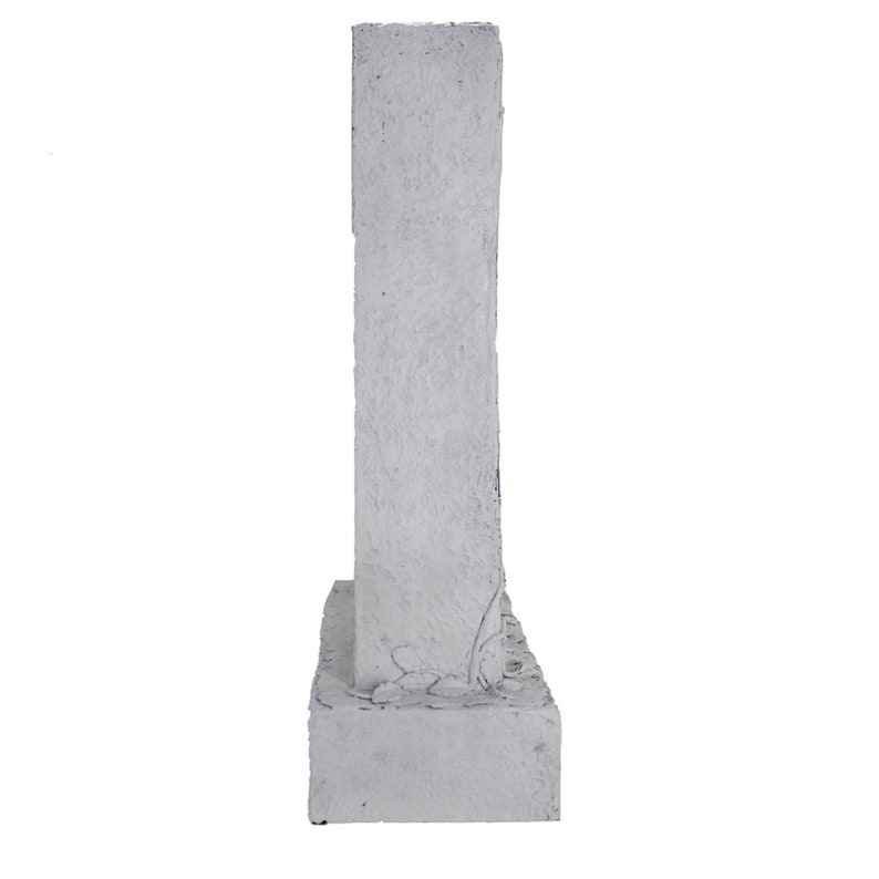May include: A white concrete garden statue with a textured surface and a floral design. The statue is tall and narrow, with a rectangular base.