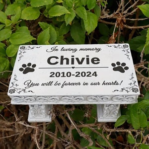 May include: White memorial bench with a paw print design and the inscription "In loving memory Chivie 2010-2024 You will be forever in our hearts!"