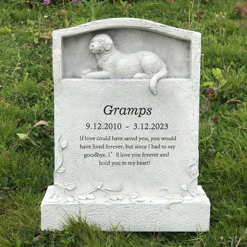 May include: White ceramic pet memorial with a sculpted dog lying down. The memorial has the inscription "Gramps 9.12.2010 - 3.12.2023" and a message about love and remembrance.