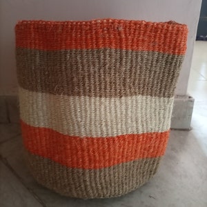 May include: A woven storage basket with a striped pattern in orange, brown, and white.