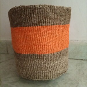 May include: A woven storage basket with a brown base and a bright orange band around the middle.