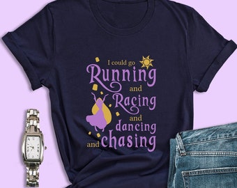 May include: A navy blue t-shirt with a purple silhouette of a woman with blonde hair and the text "I could go Running and Racing and dancing and chasing".