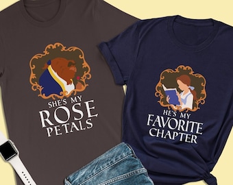 May include: Two t-shirts with a Beauty and the Beast theme. The brown t-shirt has a picture of the Beast and the text "She's my rose petals". The blue t-shirt has a picture of Belle and the text "He's my favorite chapter".