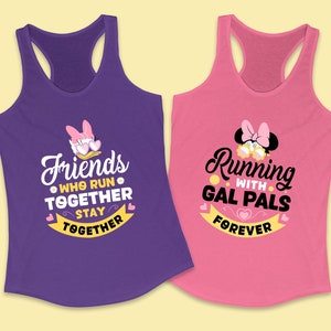 May include: Two purple and pink tank tops with a running theme. The purple tank top has a cartoon image of a duck with the text "Friends who run together stay together". The pink tank top has a cartoon image of a mouse with the text "Running with gal pals forever".