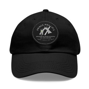 May include: Black baseball cap with a circular patch featuring a gray dragon with a sword, the text "Prince Phillip's Dragon Slayer School Est. 14th Century Sword, Shield, and Truth", and a white border.
