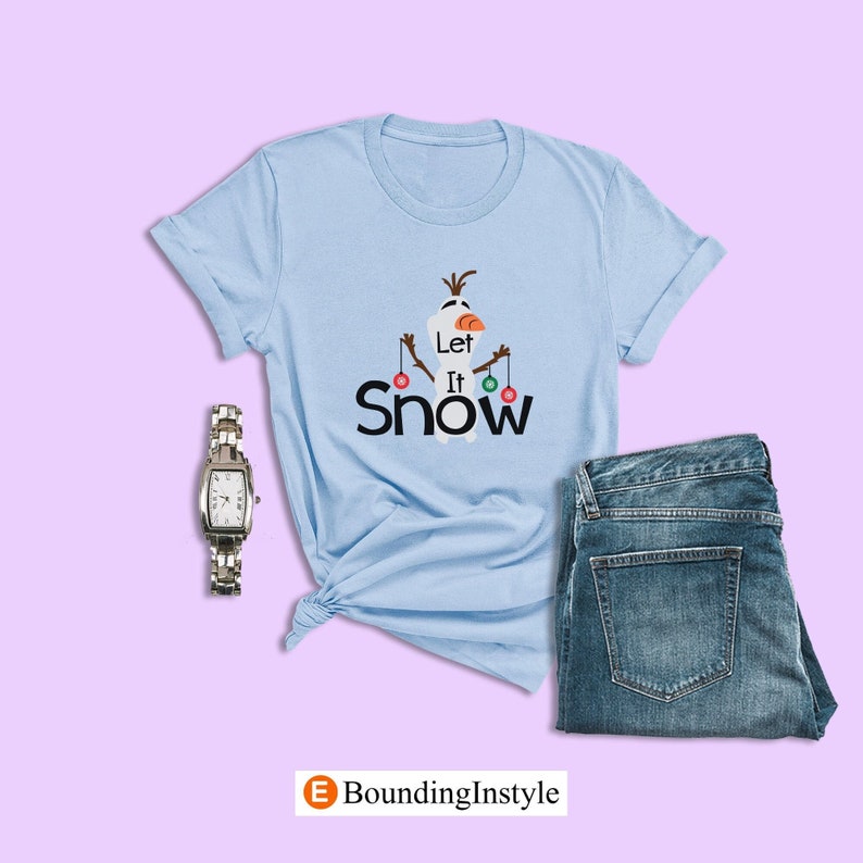 May include: Light blue t-shirt with a snowman graphic and the text "Let It Snow".