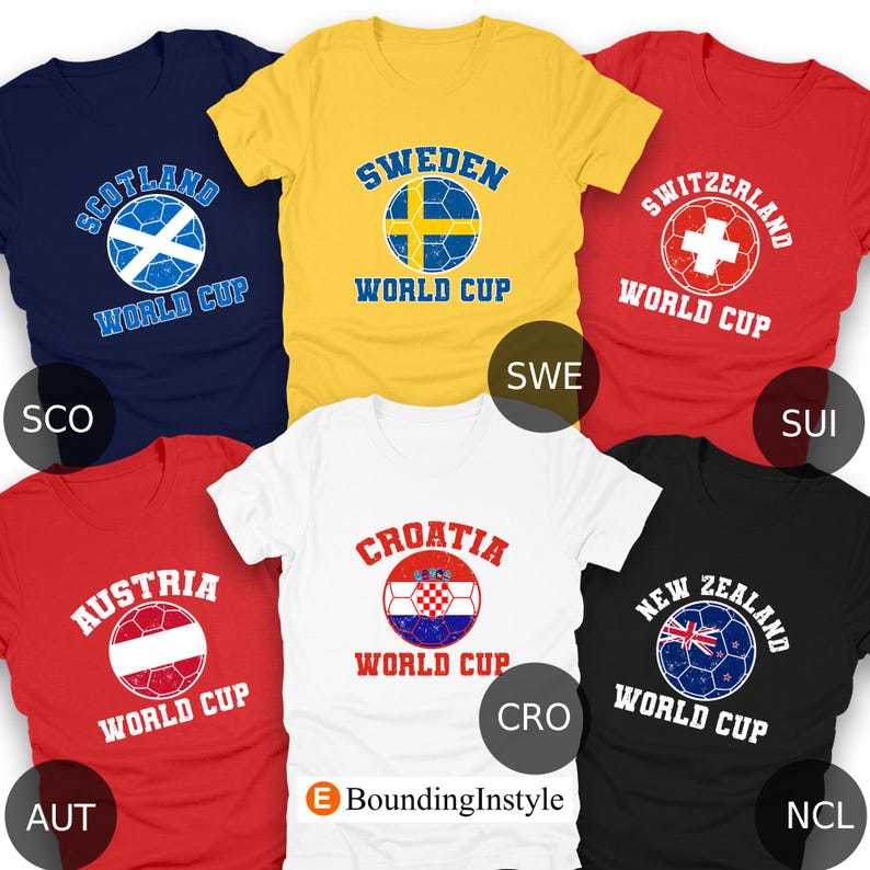 May include: A collection of six t-shirts, each featuring a soccer ball design with a country's name and "World Cup" text. Colors include navy, yellow, red, white, and black. The shirts display the flags of Scotland, Sweden, Switzerland, Austria, Croatia, and New Zealand.