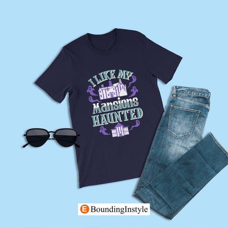 May include: A navy blue t-shirt with a graphic of a haunted mansion and the text "I like my mansions haunted".