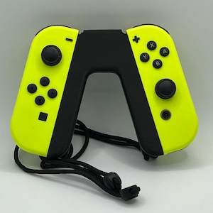May include: A bright yellow Nintendo Switch Joy-Con controller with black buttons and a black strap. The controller is in a detached position, ready for use.