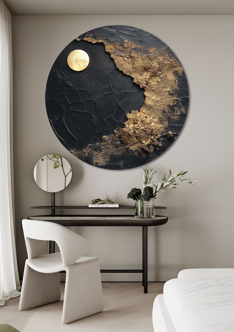 May include: A round black and gold abstract wall art piece with a textured surface. The art piece features a large gold circle in the upper right corner.