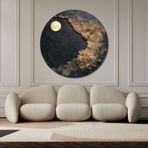 May include: A circular abstract painting with a black and gold color scheme. The painting features a textured surface with a large, round, gold shape in the upper left corner.