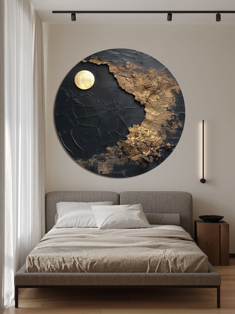 May include: A round black and gold abstract wall art piece with a textured surface. The art piece features a large gold circle in the upper right corner.