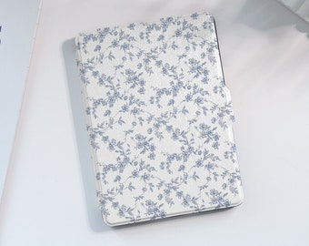 May include: A white e-reader case with a blue floral pattern.
