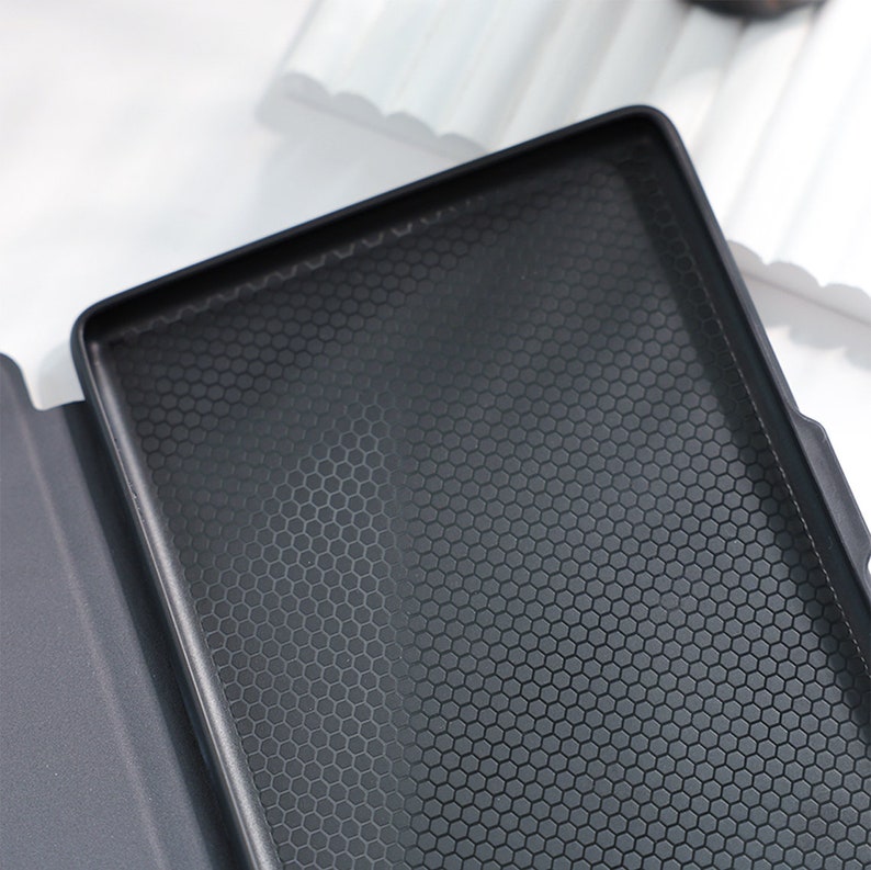May include: Black case with a honeycomb pattern on the inside. The case is made of a soft material and has a smooth, matte finish.