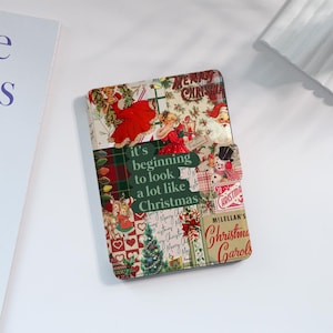 May include: A red, green and white Christmas themed notebook cover with a collage of vintage images and the text "it's beginning to look a lot like Christmas".