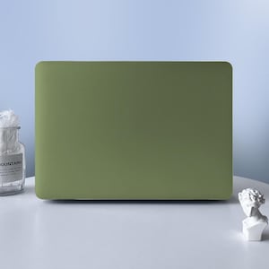 May include: A solid olive green laptop case with a smooth, matte finish. The rectangular cover features rounded corners and a clean, minimalist design that covers the entire top surface of the device, providing a uniform colour appearance.
