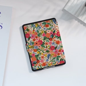 May include: A black e-reader case with a floral pattern. The case features a variety of colorful flowers, including pink, red, yellow, and blue, on a cream background.