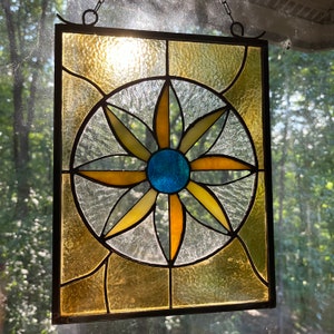 Stained Glass window panel, floral design in a Craftsman Style.  The ambers, blues, yellows, and textured glass add the wow to any room.