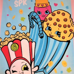 May include: A blue and white striped bag with a pink lipstick, a brown cookie character, and a popcorn character with a red and white striped container. The characters have smiling faces and large eyes. The background is light blue with gold coins and hearts.