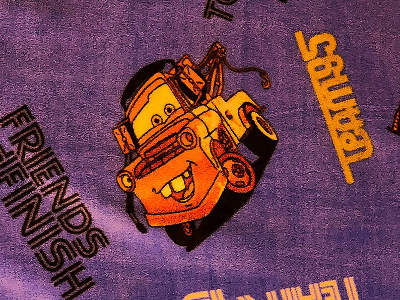 May include: A purple blanket with a cartoon image of a yellow tow truck with a smiling face. The text "FRIENDS FINISH" is printed in black on the blanket. The text "Salvation" is printed in yellow on the blanket.