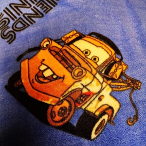 May include: A yellow and orange tow truck with a smiling face, on a blue background with the text "Friends are the best" in black.