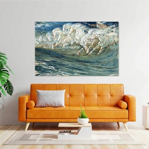 May include: A painting of white horses running through the ocean waves. The water is a deep blue and green, and the horses are white with a hint of gold. The painting is framed and hanging on a white wall.