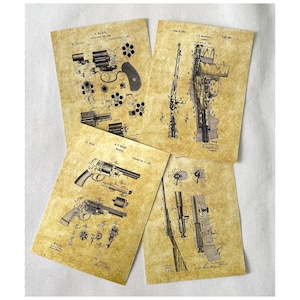 May include: Set of four vintage-style prints featuring black and white illustrations of antique firearms. The prints are on a textured, aged paper background. The prints include the text "W. MARLIN" and "P.T. SHARP".