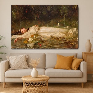May include: A large canvas print of a classical painting showing a woman in a white dress floating in water, surrounded by lily pads and foliage. The artwork is displayed above a beige sofa with orange cushions.