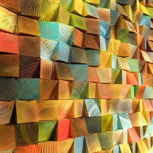 May include: A wall made of colorful wooden blocks, each block is a different shade of green, blue, yellow, red, and brown. The blocks are arranged in a geometric pattern, creating a unique and modern design.