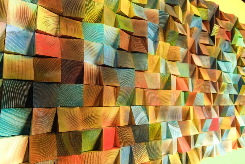 May include: A wall made of colorful wooden blocks, each block is a different shade of green, blue, yellow, red, and brown. The blocks are arranged in a geometric pattern, creating a unique and modern design.