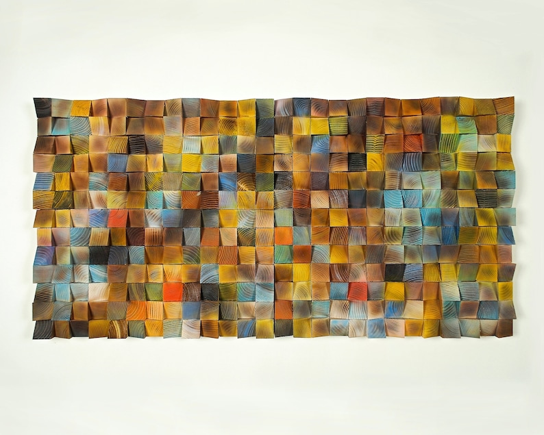May include: A wall art piece made of wood with a mosaic of squares in various shades of brown, yellow, blue, and red.