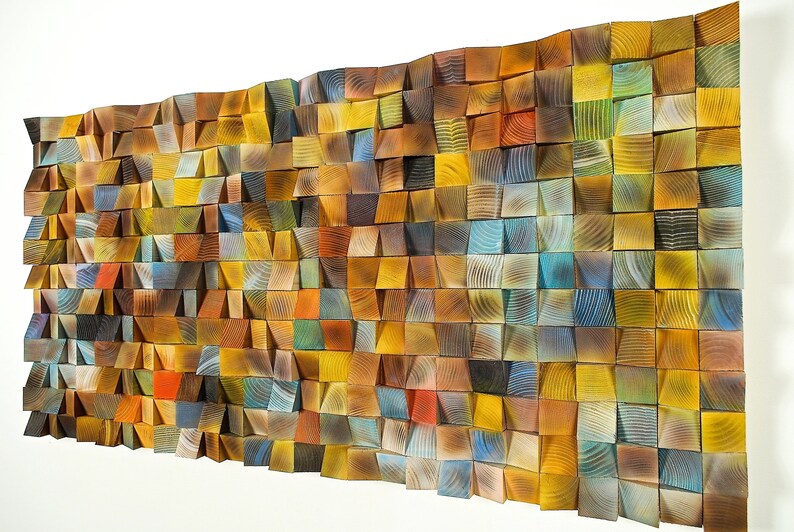 May include: A wall art piece made of wood with a variety of colors and textures. The wood is arranged in a geometric pattern, creating a unique and modern look.