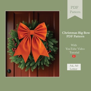 May include: A Christmas wreath with a large orange bow. The wreath is made of green pine branches and red berries. The text "Christmas Big Bow PDF Pattern" is displayed on the right side of the image.