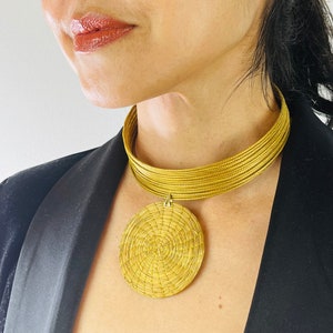 Golden vegetable choker made of golden grass from Brazil. Gold choker in capim dourado. Multi-row necklace and its gold mandala. Jewelry from Brazil.