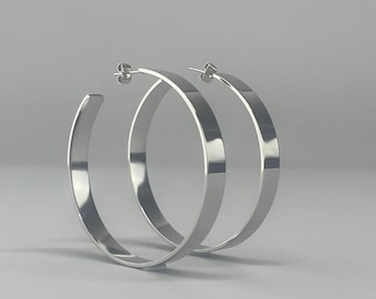 Large stainless steel hoop earrings. Oversized silver-colored hoop earrings. Large flat silver-colored hoop earrings. Modern flat hoop earrings.