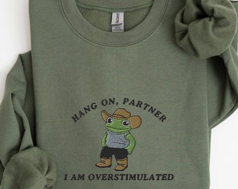 Hold On Partner I’m Overstimulated Embroidered Sweatshirt, Cowboy Frog Unhinged Shirt, Weirdcore Gen Z Crewneck Sweatshirt, Funny Frog Shirt