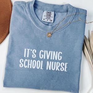 Comfort Colors® It&#39;s Giving School Nurse Shirt, School Nurse Tshirt, Nurse Life Teacher Shirt, School Nurse Gift, Back to School, Spirit Day