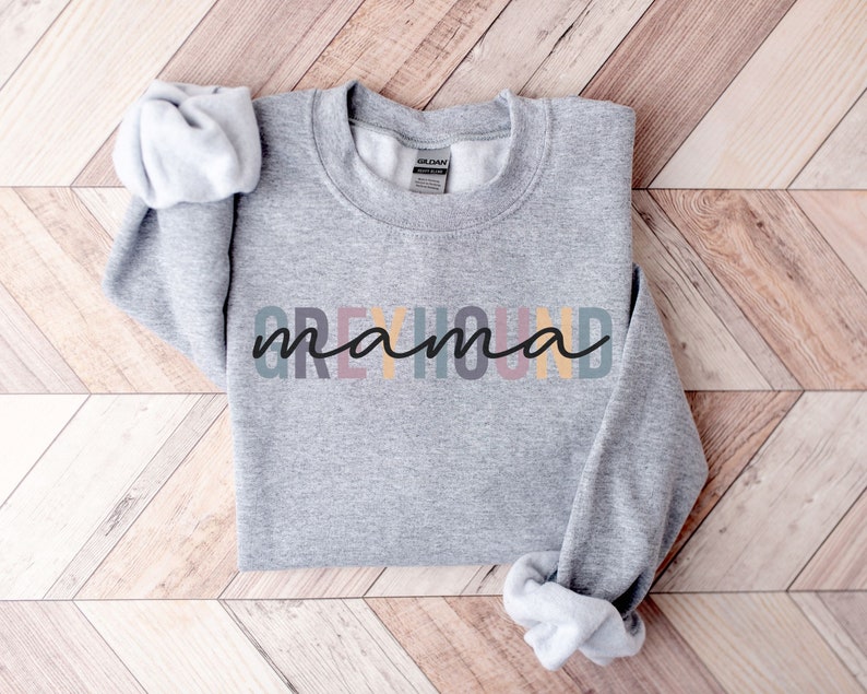 May include: Gray sweatshirt with the text "Greyhound mama" in rainbow colors.