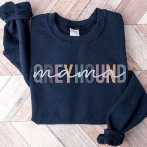 May include: A navy blue sweatshirt with the text "Greyhound mama" in colorful letters.