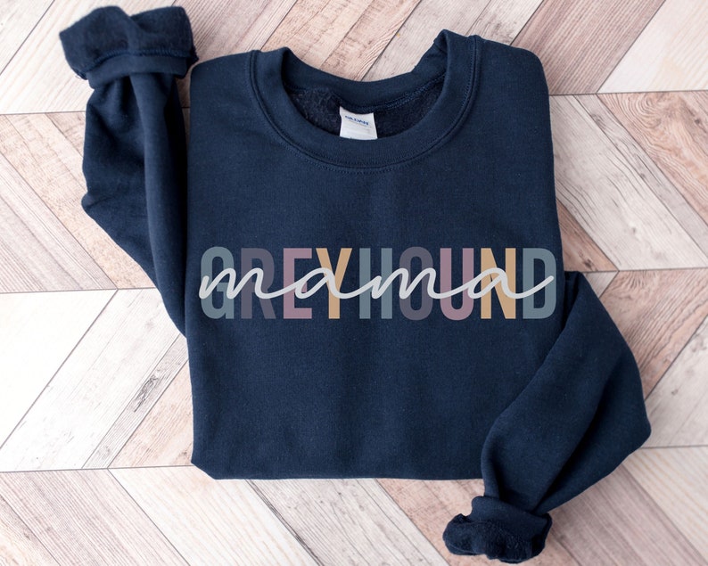 May include: A navy blue sweatshirt with the text "Greyhound mama" in colorful letters.