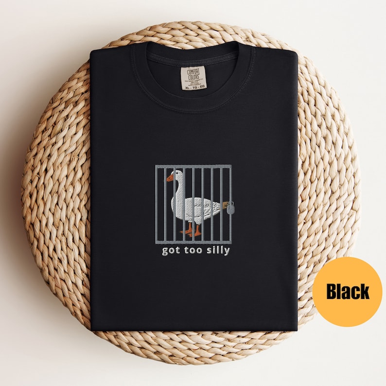 May include: Black t-shirt with a white goose in a cage and the text "got too silly".