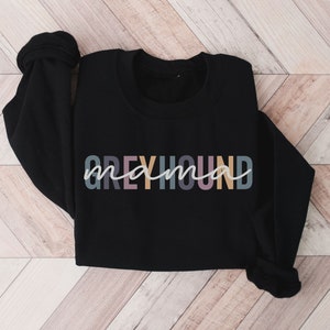 May include: Black sweatshirt with the text "Greyhound mama" in colorful letters.