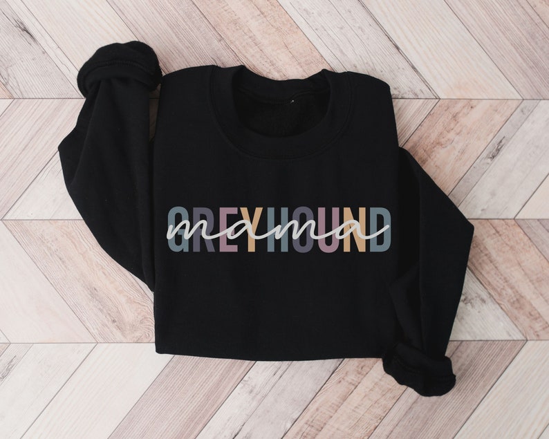 May include: Black sweatshirt with the text "Greyhound mama" in colorful letters.