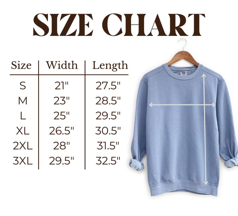 May include: A light blue sweatshirt hangs on a wooden hanger, with a size chart displayed to the left. The chart shows measurements for width and length in inches for sizes S through 3XL. The text "SIZE CHART" is at the top.
