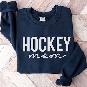 May include: A navy blue sweatshirt with the text "HOCKEY mom" in white lettering.